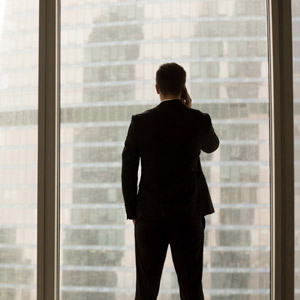 Man at a window with a cell phone
